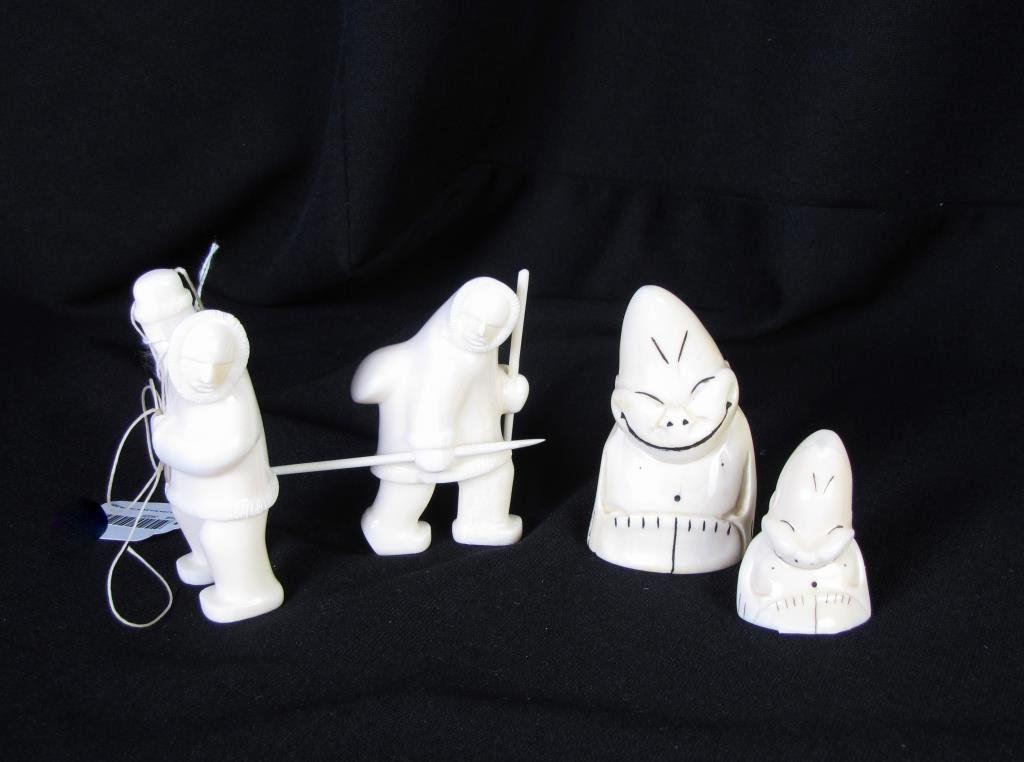 Four Alaskan Ivory Figures: A group of four Alaskan ivory figures, including two Eskimos, one with rope, and other with spear and walking stick, both 3.5" tall, and two other figures, measuring 2" and 3.5" tall