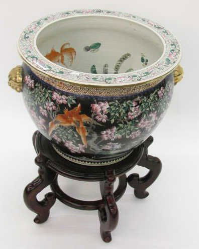 Oriental Porcelain Fish Bowl: An Oriental porcelain fish bowl, with koi fish decoration on interior, on wooden pedestal
