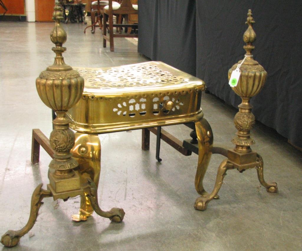 Group of Antique Fireplace Accessories: A group of antique fireplace accessories including a pair of brass andirons with ball and talon foot, and a brass fireplace trivet