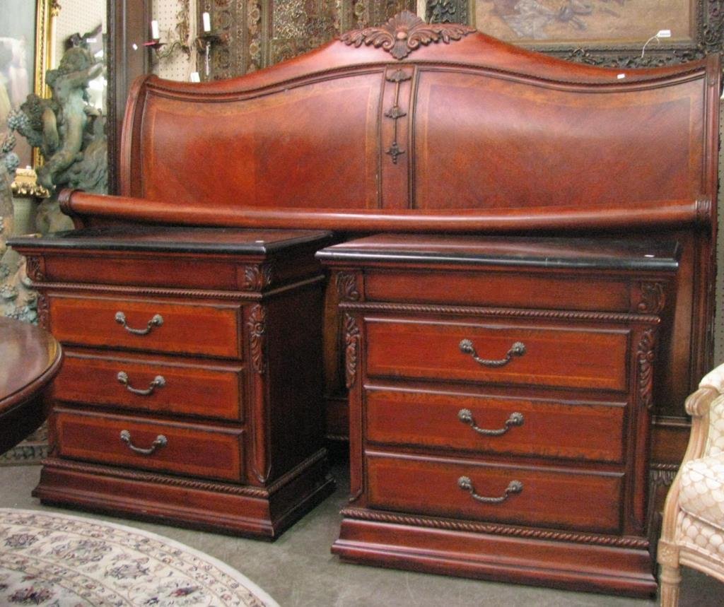 Carved Mahogany King Size Bedroom Suite: A carved mahogany king size bedroom suite with sleigh bed, a pair of large nightstands with faux marble tops, and triple dresser with mirror
