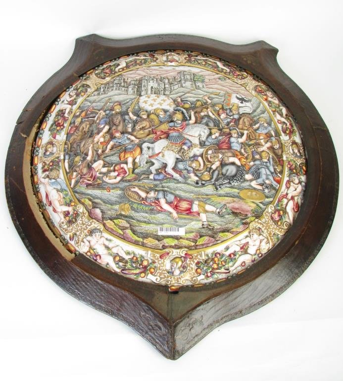 Large Capodimonte Porcelain Charger: A large Capodimonte porcelain charger depicting a battle scene, 20.5" diameter, presented in leather wrapped wood frame with embossed decoration (frame needs repair; plaque is not secure in frame), ov