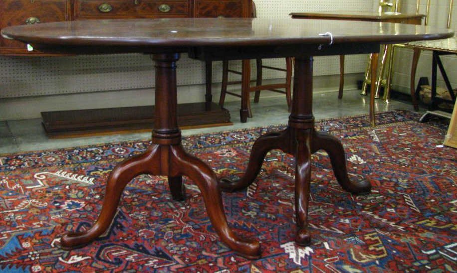 Henkel-Harris Oval Mahogany Dining Table: A Henkel-Harris oval mahogany dining table, style no. 2209, with double pedestal Queen Anne style base, includes five 12" leaves, table without leaves measures 66" x 48", one dime-size imperfection on