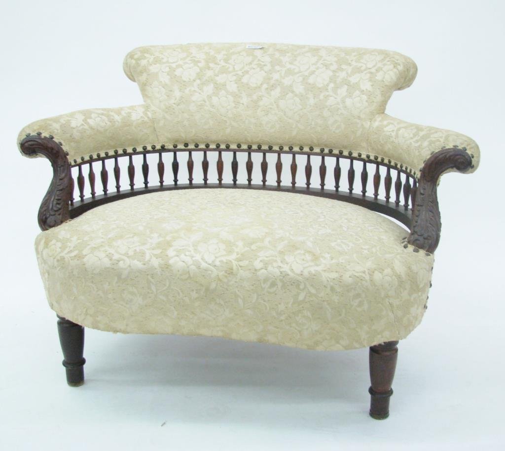 Unique Antique Settee: An unique antique settee with carved arms and spindle back, loose frame