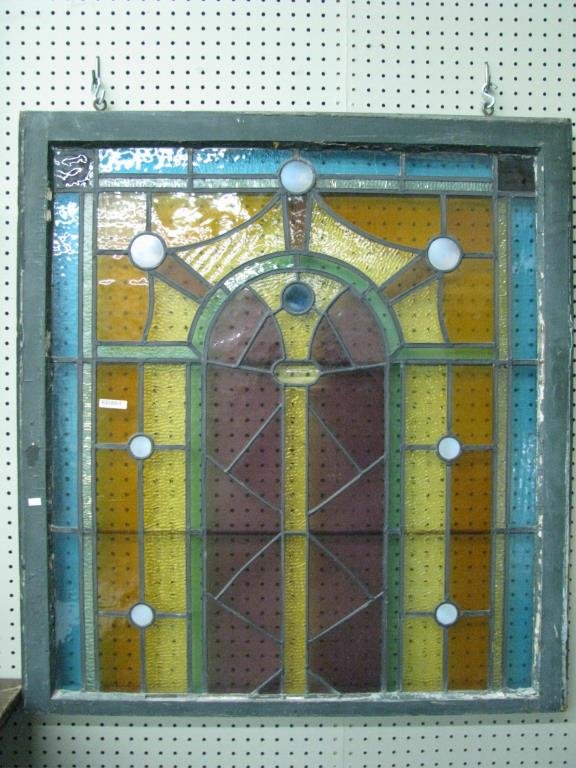 Antique Stained Glass Window: An antique stained glass window with opalescent beads, frame measures 36" x 39", a few minor cracks