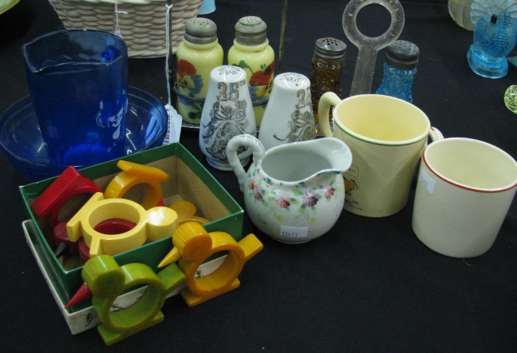 Group of Antique & Vintage Table Accessories: Group of antique and vintage table accessories including set of 8 Bakelite napkin rings, Shirley Temple pitcher, salt and pepper shakers with caddies, two cartoon mugs and cream pitcher