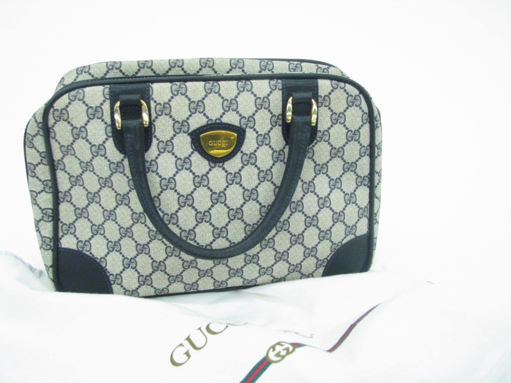 Vintage Gucci Navy Logo Bag: Vintage Gucci navy logo "Speedy Boston" bag with two top handles. Navy leather accent trim, zip top closure and two interior zip pockets. Includes dust bag. 9" tall, 12 1/2" long and 5" deep