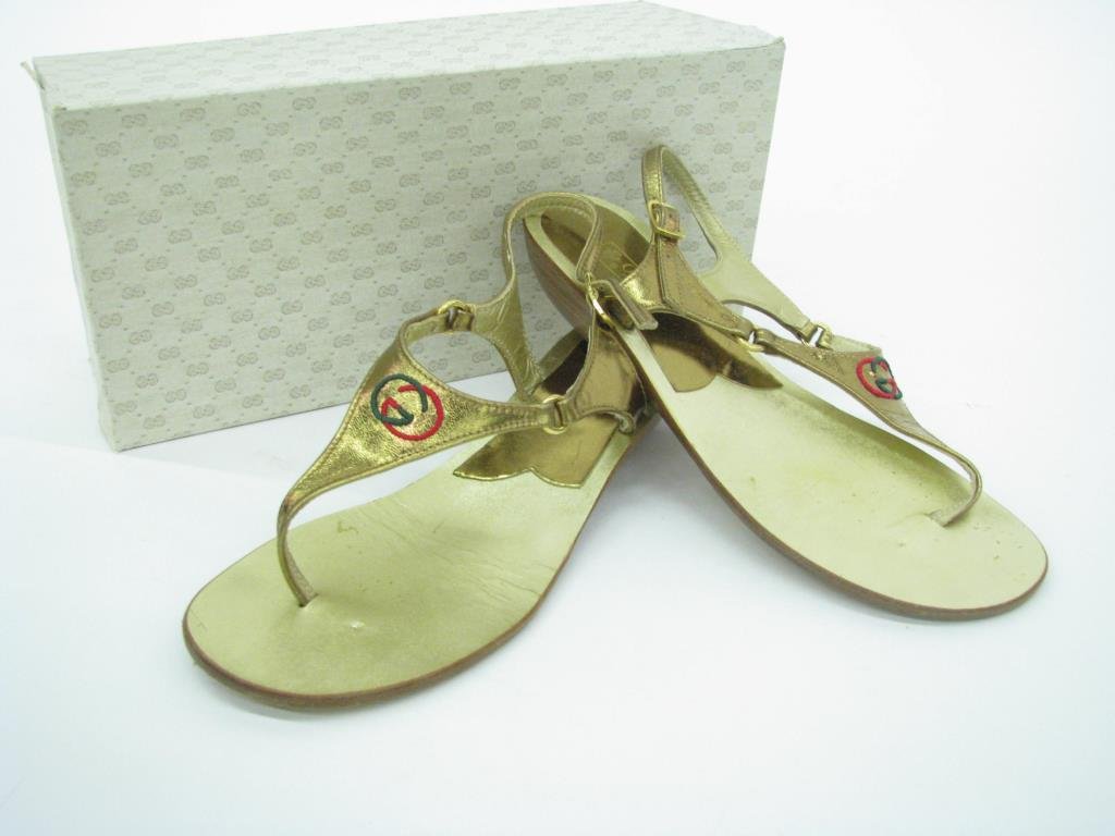 Gucci Gold Metallic Leather Sandals: Pair of vintage Gucci gold metallic leather sandals with logo. Gold tone hardware with slight wedge heel. Size 37. In original box, purchased March 1988