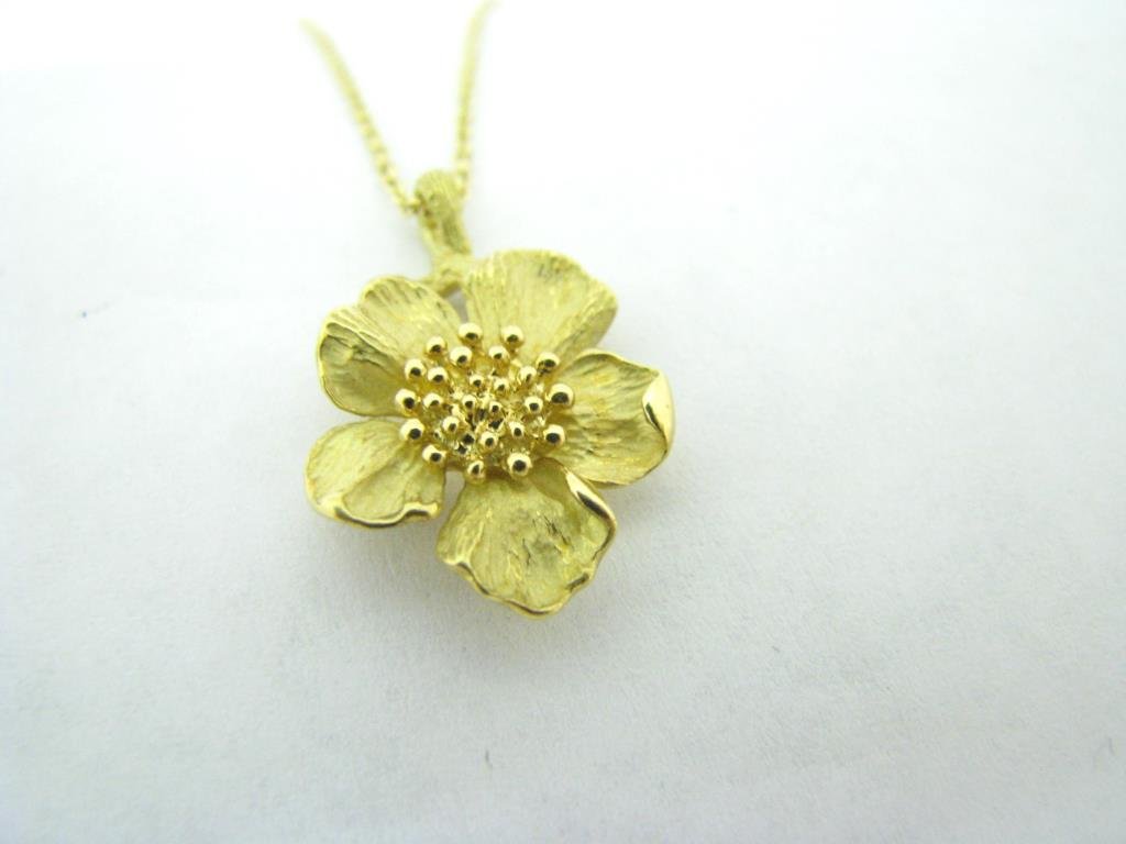 Tiffany 18K Yellow Gold Floral Pendant, Chain: Tiffany & Co. 18K yellow gold wild rose floral pendant on 16" Tiffany & Co. 18K yellow gold chain with spring ring clasp. Pendant is 22 mm x 15 mm and marked T & Co. 750. Comes in presentation box