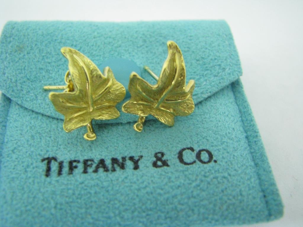 Tiffany 18K Maple Leaf Earrings: Tiffany & Co. 18K yellow gold maple leaf pierced earrings with post style backs. The earrings are 16 mm x 12 mm and marked T & Co 750. Includes felt bag