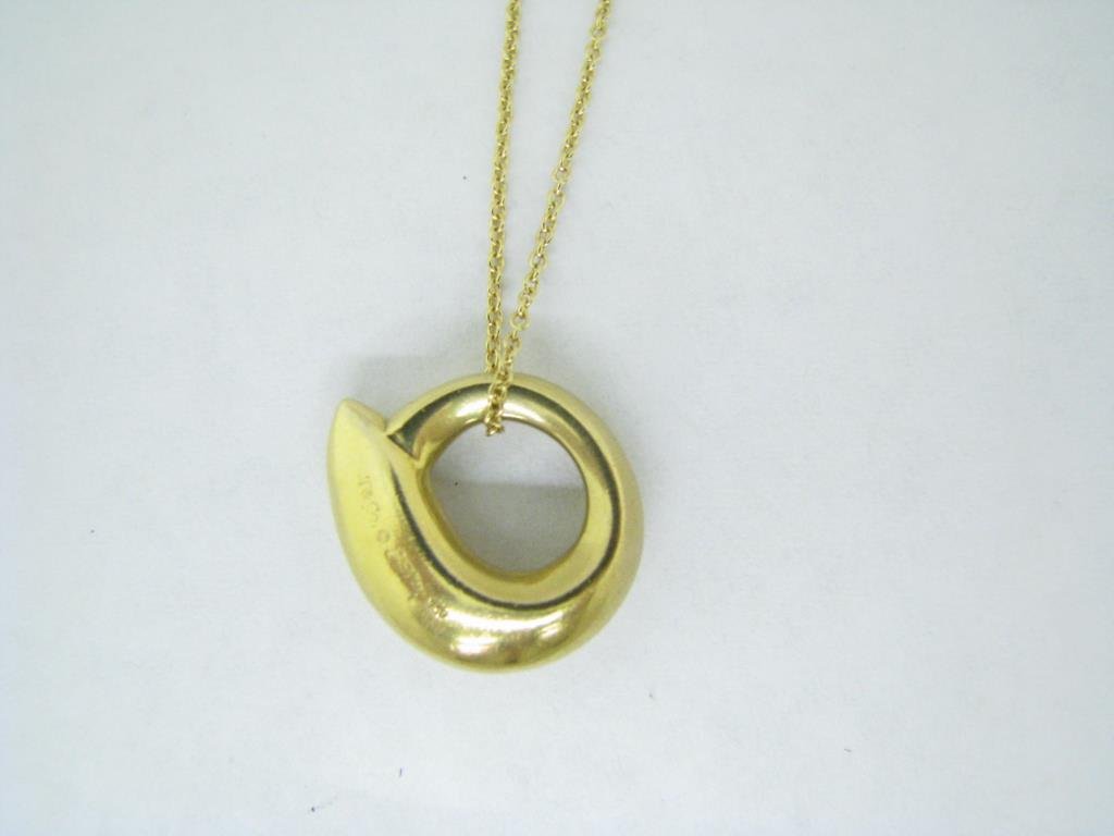 Tiffany 18K Frank Gehry Pendant, Chain: Tiffany & Co. 18K yellow gold Frank Gehry free form pendant on Tiffany & Co. 18K yellow gold 16" thin chain with spring ring clasp. It is marked T & Co Gehry 750. Discontinued design. Comes with prese