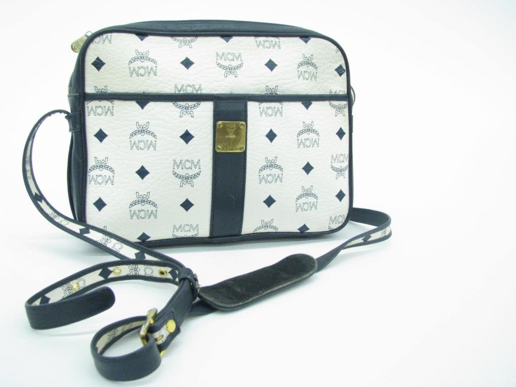 Mode Creation Munich White/Navy Leather Logo Bag: Mode Creation Munich (MCM) white and navy leather logo shoulder bag designed by Patricia Cromer. Gold tone hardware, adjustable shoulder strap. Exterior pocket. Zip top closure with two interior pocke