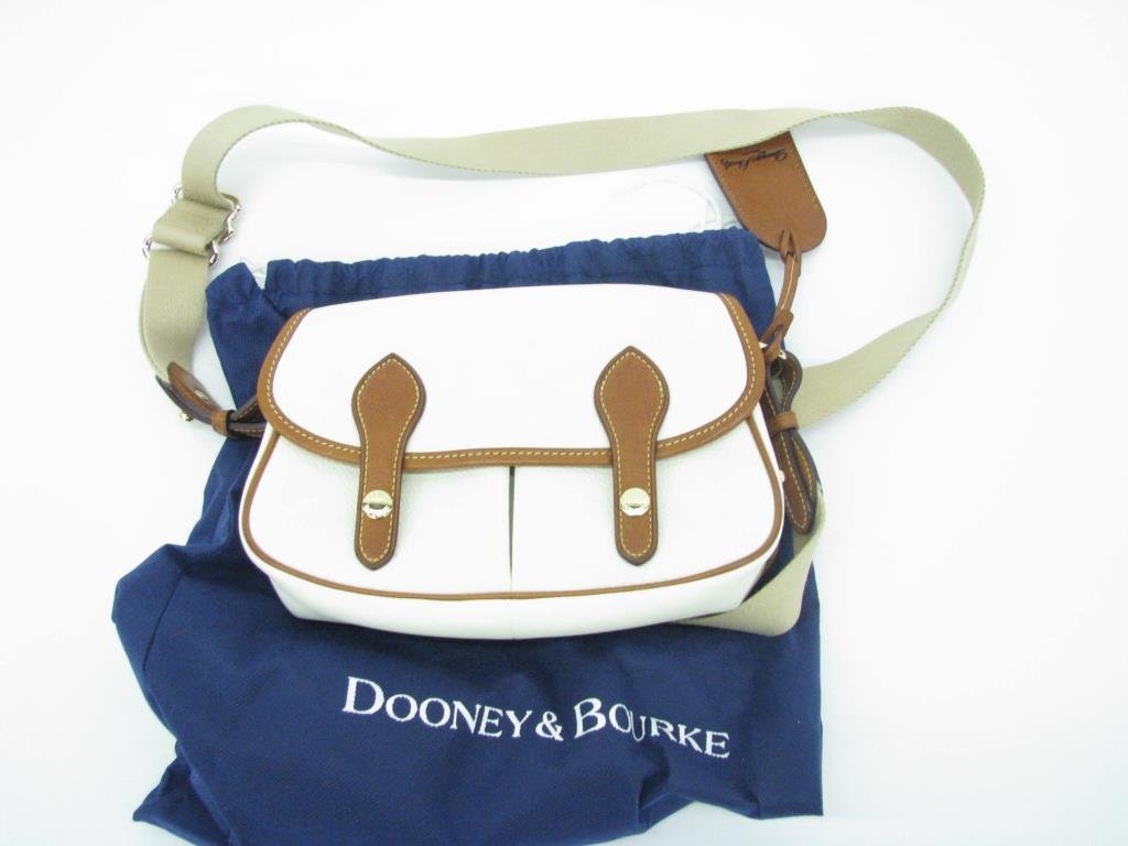Dooney & Burke White Leather Shoulder Bag: Dooney & Bourke white leather shoulder bag with brown leather trim. Bag has adjustable canvas and leather shoulder strap. Gold tone hardware. Exterior snap close pocket. Front flap closes with two sna