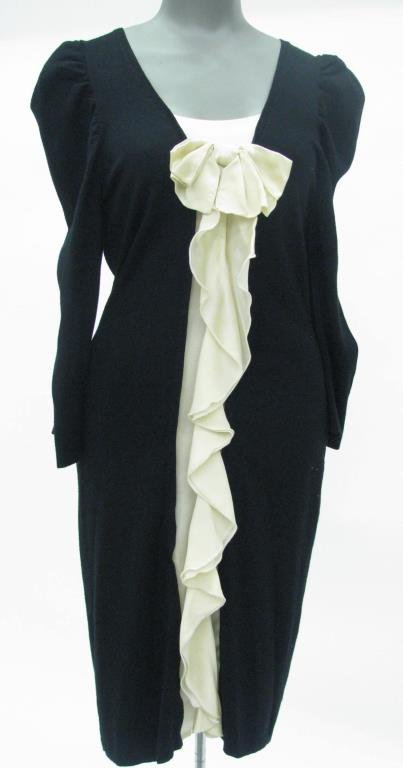 Yoana Baraschi Original Black Sweater Dress: Yoana Baraschi Original Knitwear black long sleeve sweater dress with ivory bow and ruffle down front center. Dress is straight line knit with ribbed cuff, angular waistline and hemline. Size M