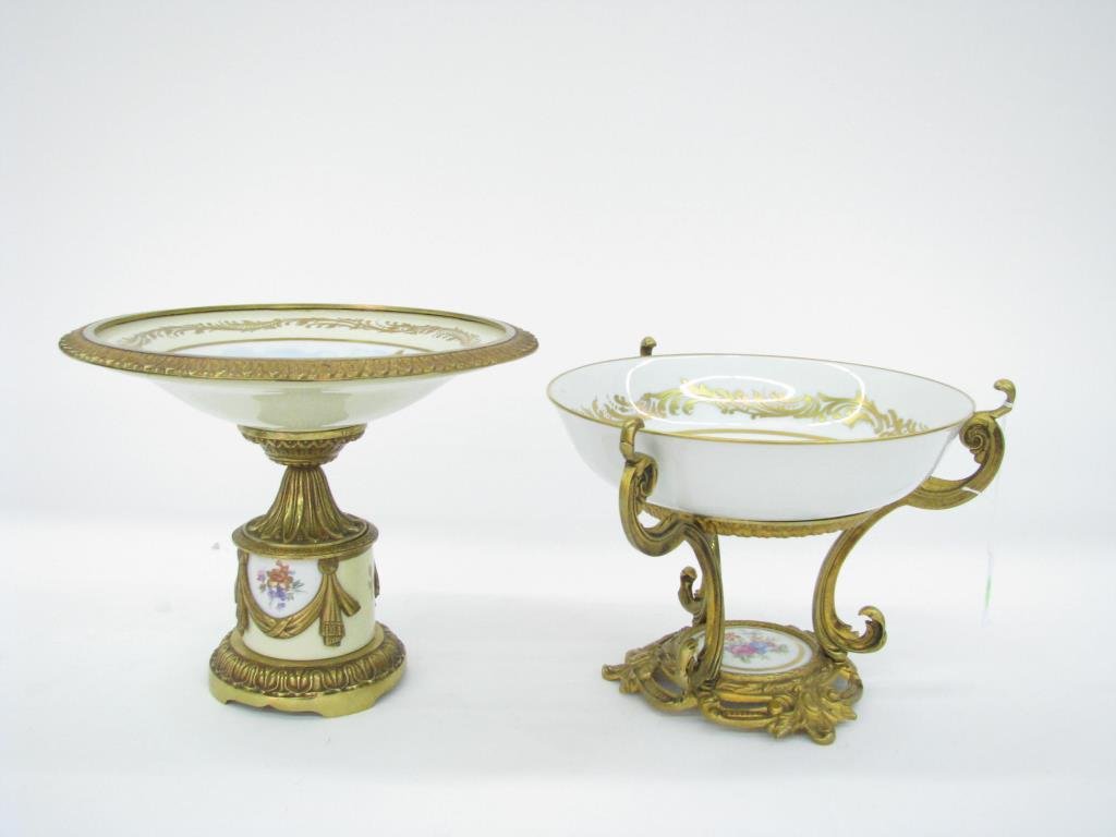 Two French Porcelain Consoles: Two 20th century French porcelain consoles including one with hand painted romantic couple, artist signed, with gilt base and trim, 8" high; and one with hand painted floral base and top in gilded fra