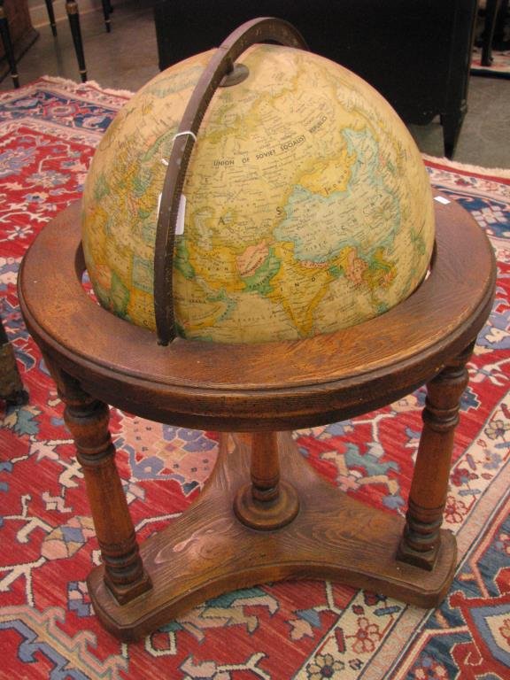 Vintage Globe on Stand: A vintage globe on stand with Replogle 16" world classic globe, on oak, triple leg base