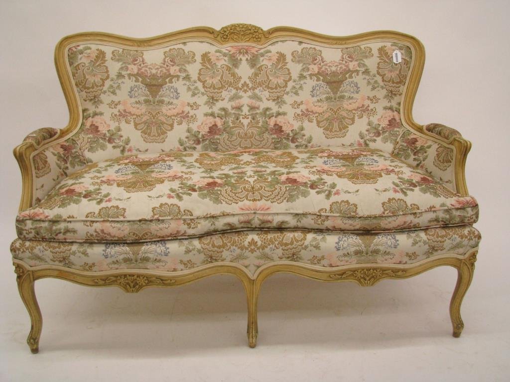 French Style Upholstered Settee: A French style upholstered settee, carved frame with bleached finish, down cushion, circa mid 20th century