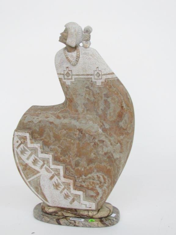 Adrian Wall Carved Stone Figure: An Adrian Wall carved stone figure, 25" high on marble base, depicting Native American Woman