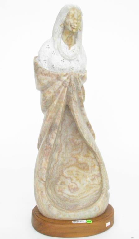 Adrian Wall Carved Stone Figure: An Adrian Wall carved stone figure, 28" high on wood base, depicting Native American woman