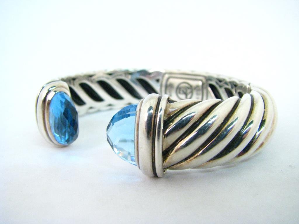 David Yurman Sterling Blue Topaz Waverly Cuff: A David Yurman sterling silver Waverly hinged wide cuff bracelet with faceted large blue topaz stones, 29.9dwt, approximately 2.25 x 1.75" interior dimensions