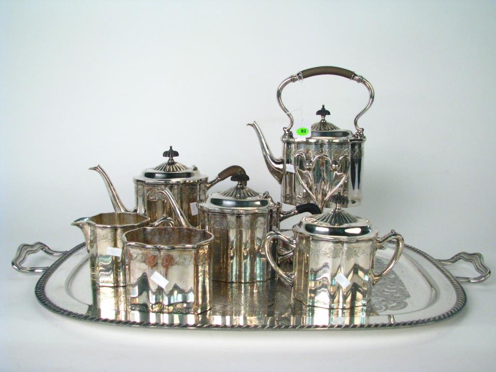 Silver Plated Tea Service: A silver plated tea service by E. G. Webster and Son, hand chased decoration, including water kettle; coffee pot; tea pot; waste jar; creamer and sugar; selling with coordinating handled tray