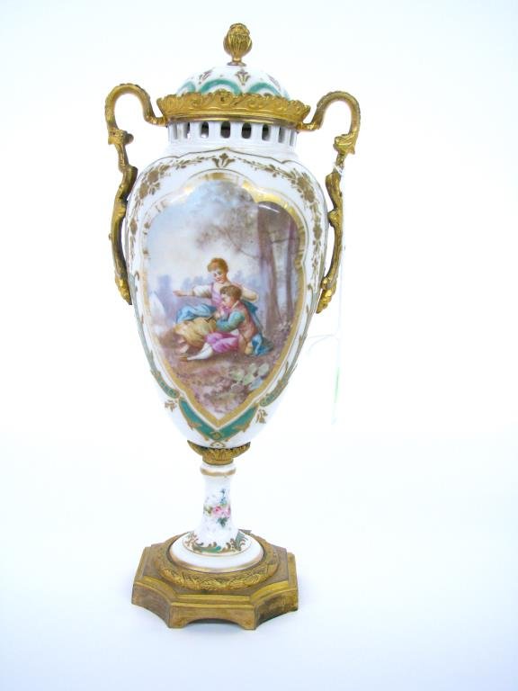 Scenic Painted Viennese Porcelain Urn: A scenic painted Viennese porcelain urn with gilt metal base and mounts, scenic depiction of romantic couple, lid repaired, wear consistent with age to enameling, 12" high
