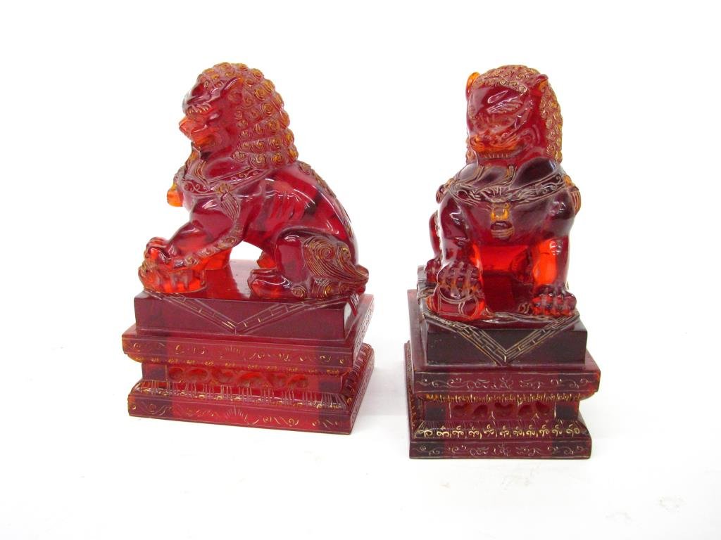 Pair of Cherry Amber-Type Foo Dogs: Pair of hand-carved cherry amber-type foo dog statues, 14" high