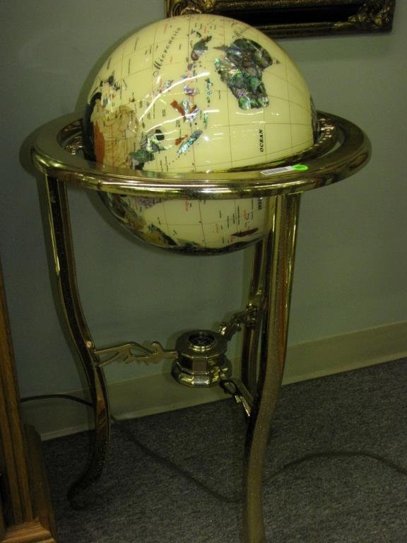 Decorative Mineral Globe on Stand: A decorative mineral globe on brass finish stand with ivory colored globe inlaid with semi-precious stones, 34" high
