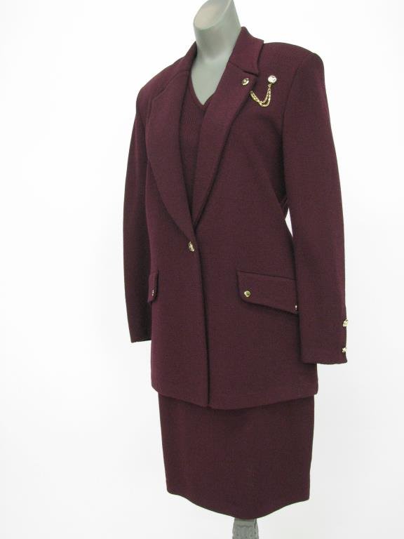 St. John Collection Burgundy Santana Knit Suit: St. John Collection by Marie Gray burgundy Santana knit suit. Jacket features single gold tone button with gold tone chain at lapel and two faux flap pockets. Size 4. Matching pull on skirt. Size 6. I