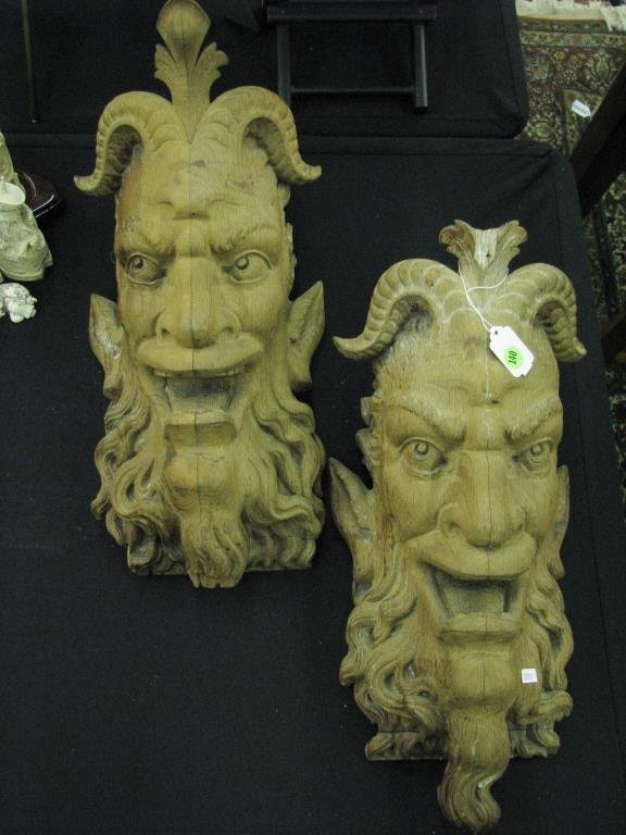 Pair of Carved Grotesque Figural Corbels: Pair of carved wooden grotesque figural corbels, approximately 20" high, one with damage on top adornment