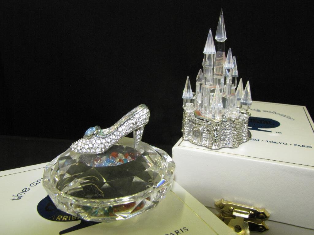 Two Arribas Swarovski Crystal Figures: Two Arribas Swarovski crystal figures, glass slipper crystal treasure box, with multiple color Swarovski crystals inside and Magic Kingdom Castle