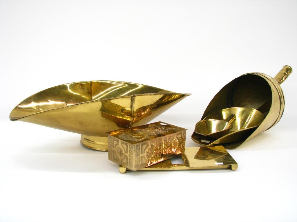 Group of Brass Finish Accessories: A group of brass finish metal accessories including three ash scoops; ash bin; trivet; hinged lid wooden match box with brass finish, embossed metal wrap