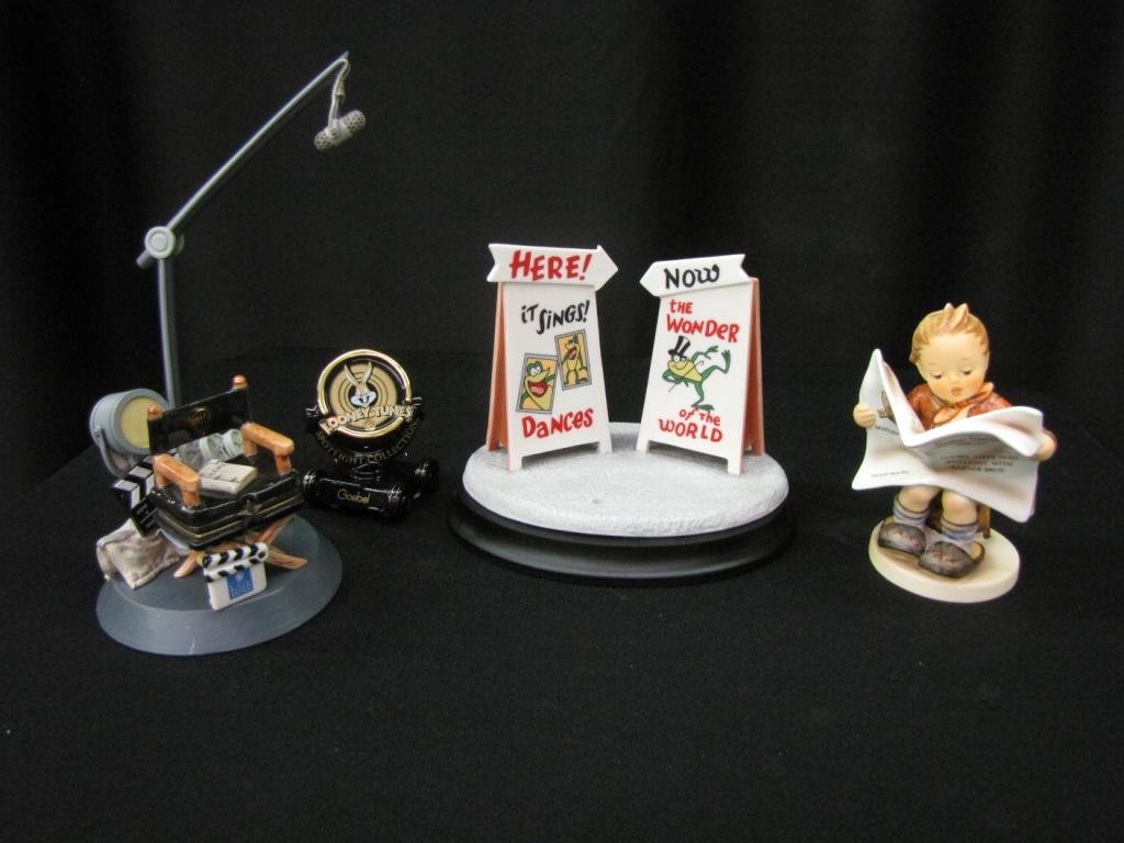 Warner Bros. Figurine, Goebel Figure, Accessories: Porcelain Warner Bros. Figurine, and accessories including: Goebel figurine depicting a boy reading the Goebel Gazette (without original box), Looney Toons Spotlight, "Michigan Rag" (#409/10,098) with