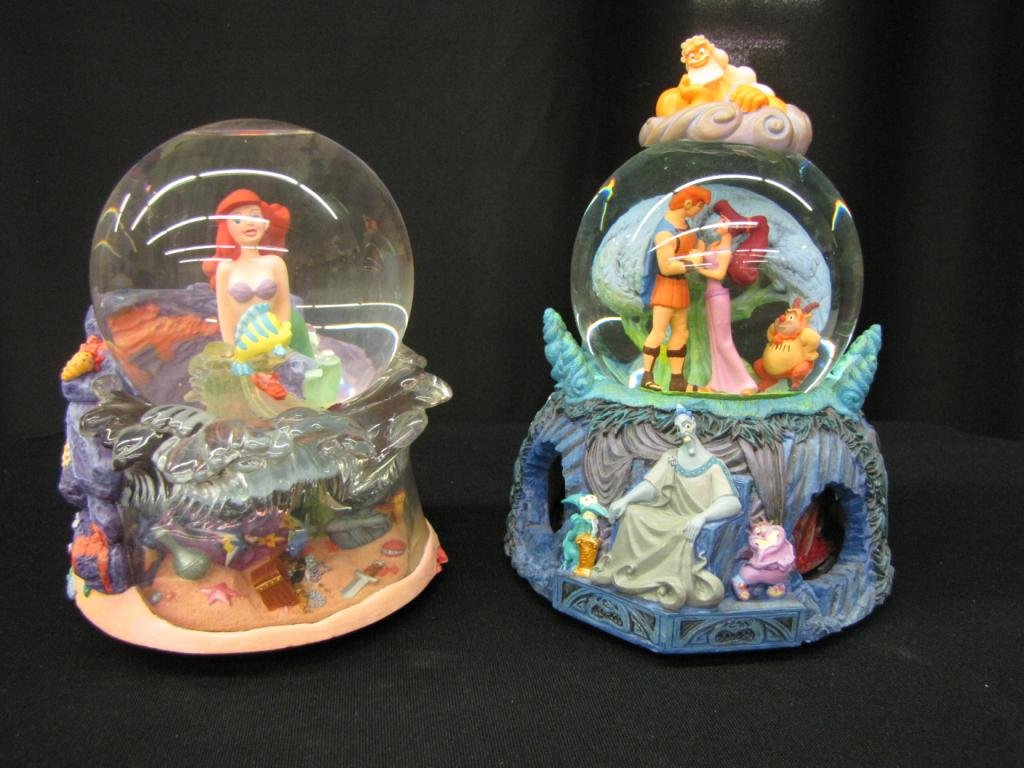 Two Disney Snow Globes: Two Disney Snow Globes featuring the Little Mermaid and Hercules, With original boxes, 7-9" tall
