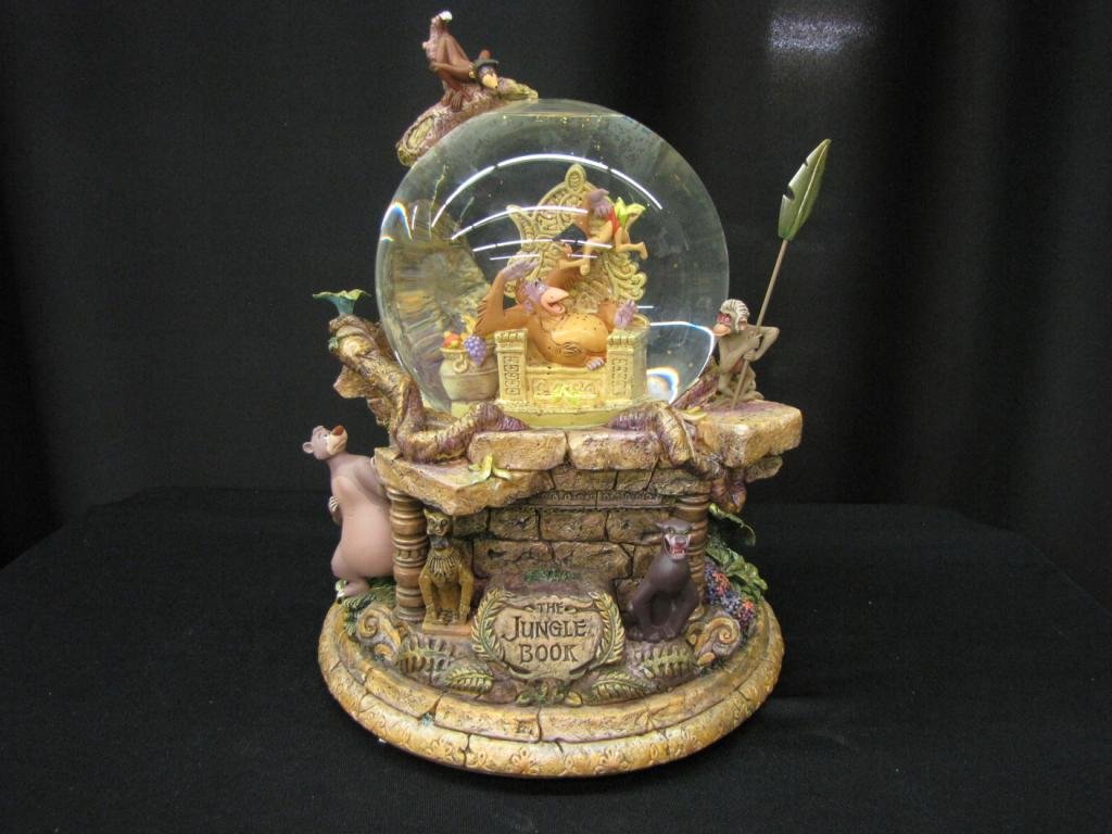 Disney Snow Globe: Disney Snow Globe depicting Jungle Book anniversary, 12" tall, with original box (Tail of monkey at the top of Snow Globe missing)