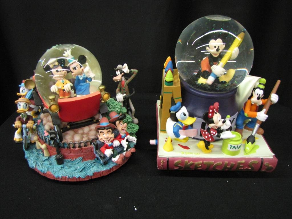 Two Disney Snow Globes: Two Disney Snow Globes depicting Mickey with pencil and friends and Mickey and Minnie driving with friends, 7-9" tall with original boxes