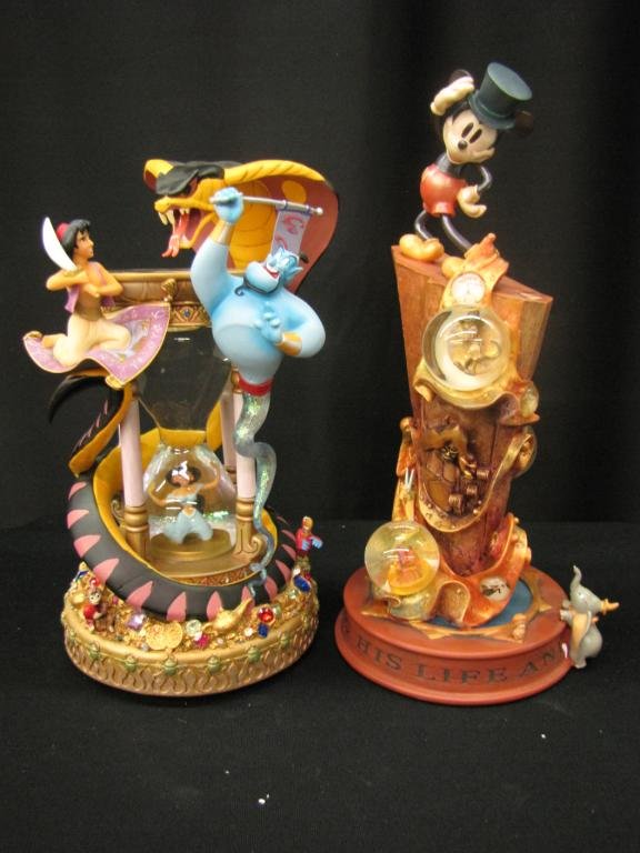 Two Disney Snow Globes: Two Disney Snow Globes depicting 100th anniversary of Mickey and Hour glass with scene from Aladdin