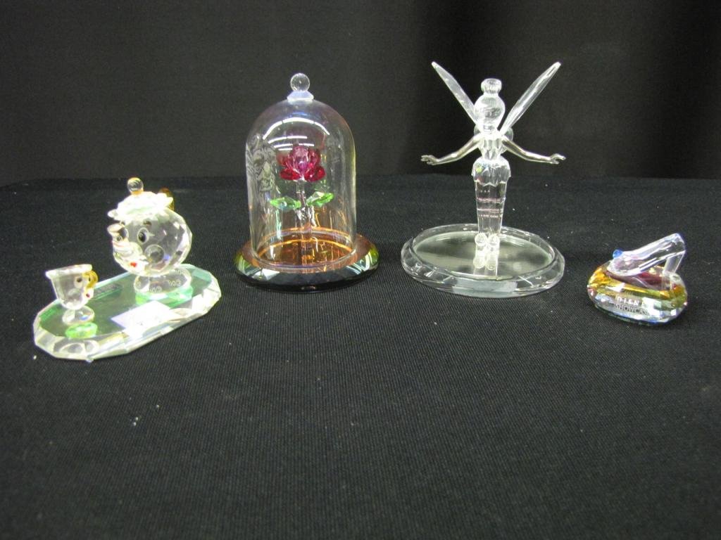 Four Disney Crystal World Figurines: Four Disney Crystal World Figurines depicting: Tinker Bell with metal arms and stand, Mrs. Pots and Chip, Cinderella's glass slipper, and the enchanted rose with glass dome. 2"-4" tall, with original