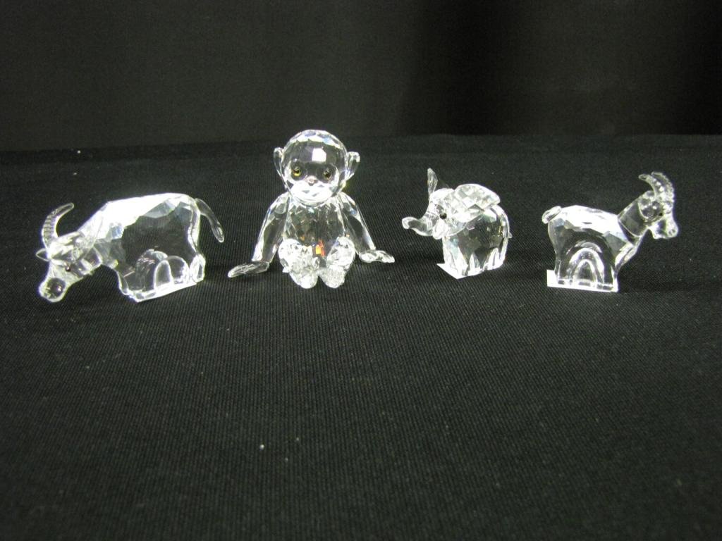 Four Swarovski Crystal Figurines: Four Swarovski Crystal Figurines depicting: Water Buffalo, elephant, monkey, and a goat, 1-2" tall, with original boxes