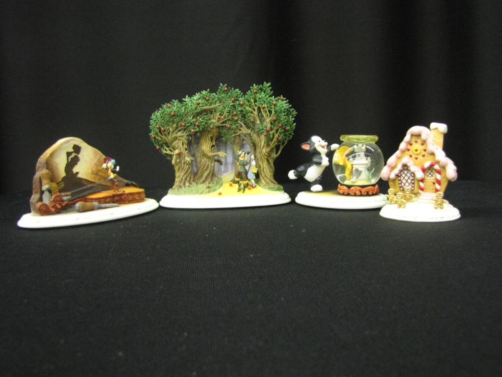 Four Olszewski Porcelain Figural Groupings: Four Olszewski Porcelain Figural Groupings depicting Figaro with fish in bowl, Jiminy Cricket, Ginger bread house and men, and scene from Wizard of Oz, 3-5" tall, with original boxes (except for Ginge