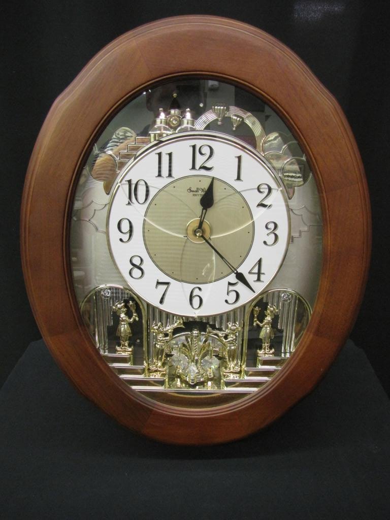 Disney Electronic Wall Hanging Clock: Rhythm wall Clock, Disney "Small World" theme, rotating face and pendulum, 20" tall