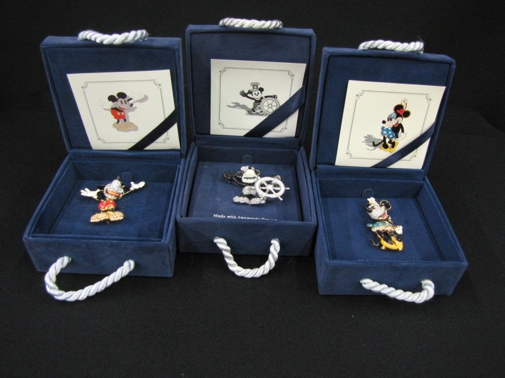 Three Swarovski Walt Disney Gallery Pins: Three Swarovski Walt Disney Gallery Pins depicting Minnie, Steam Boat Willie, and Mickey, 3" long, with original cases