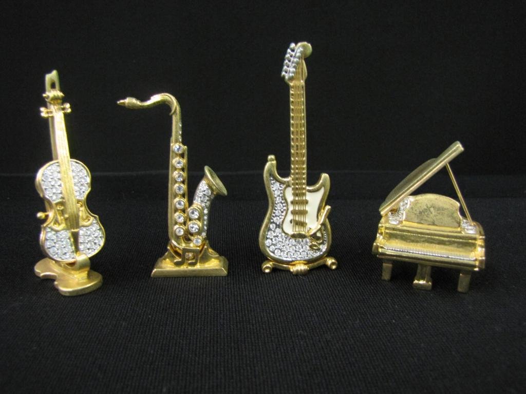 Four Oliver Weber Swarovski Crystal Figurines: Four Oliver Weber Swarovski Crystal Figurines, musical instruments including: Piano, Violin, Saxophone, and guitar, 2-3" tall, only two with original boxes