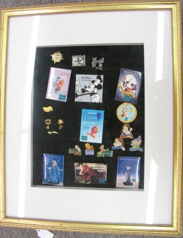 Framed Group of Twenty One Disney Pins: Framed Group of Twenty One Disney Pins including steam Boat Willie, Hercules, Mickey, Snow White, Pooh Bear, Shere Kahn, Malificient, Ariel, and other assorted pins, framed 21.5x17.5