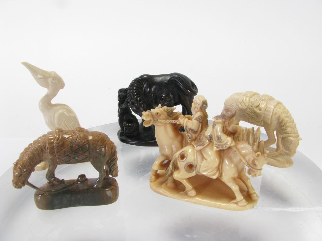 Group of Ivory and Oriental Carvings: Group of five Oriental items, including one netsuke, one wooden miniature carving with monkeys and horse, ivory horse figure, ivory pelican with fish, petrified wood carving of horse