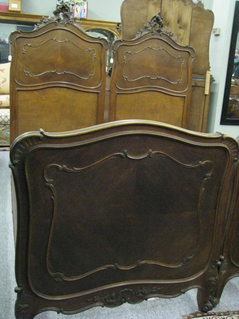 Pair of Antique French Twin Size Beds: A pair of antique, French, twin size beds, walnut with leaf and scroll carvings, on headboard and footboard, bed size is 78" x 31" (interior); headboard height 66"