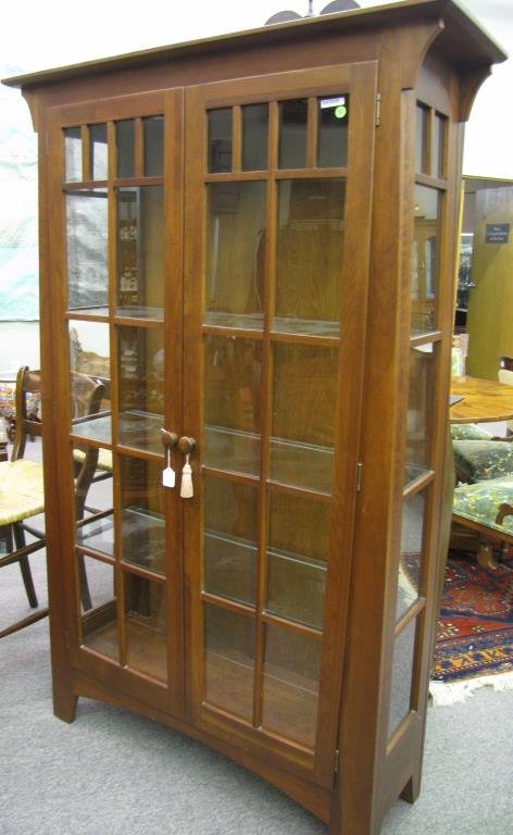 Ethan Allen Mission Style Bookcase: An Ethan Allen mission style bookcase, cherry, with adjustable shelves, canister lighting, from the American Impressions collection, 70" high x 43" x 15"