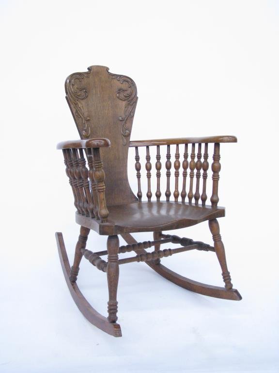 Antique Oak Rocking Chair: An antique rocking chair, with turned spindle arm supports, solid back splat with applied carvings, oak, ca 1900, 35"h