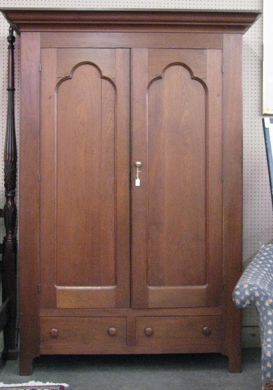 Antique Oak Wardrobe/Press: An antique oak wardrobe/linen press, with raised panel doors, recently converted with adjustable shelving, two drawers in base