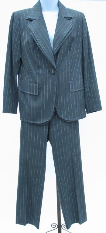 Escada Charcoal Gray Pin Stripe Suit: Escada charcoal gray pin stripe suit. Blazer with double lapel, single button and two faux front flap pockets and matching zip front pants. Size 42