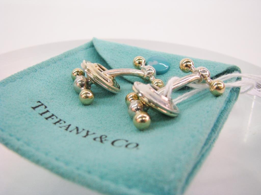 Pair of Tiffany & Co. Sterling/18K Cuff Links: A pair of Tiffany & Co. Sterling silver and 18K yellow gold barbell and disc cuff links signed Paloma Picasso.